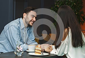 Couple In Love Smiling Each Other Having Coffee In Cafe