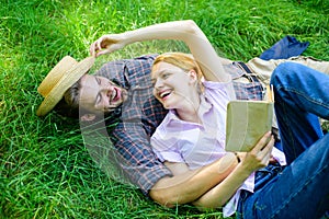 Couple in love spend leisure reading book. Man and girl lay on grass relaxing. Romantic couple family enjoy leisure with