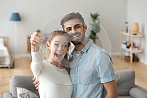 Couple in love standing in living room at new house