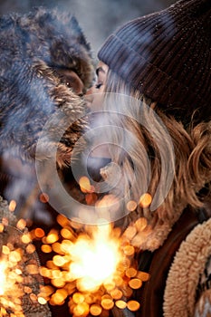 Couple Love Story in Snow Forest Kissing and Holding Sparklers. Couple in Winter Nature. Couple Celebrating. Valentine's