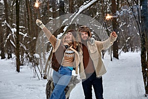 Couple Love Story in Snow Forest Kissing and Holding Sparklers. Couple in Winter Nature. Couple Celebrating. Valentine& x27;s
