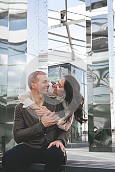 Couple in love. Stunning sensual outdoor portrait of woman hugging man on date. Happy couple dating on the street