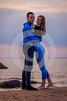 Couple in love at sunset by the sea