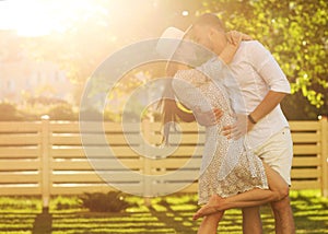 couple in love at sunset walking in the park happy, American dream. The concept of family values.