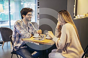 Couple in love talking on a date in a cafe