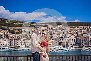 Couple in love tourists enjoying the views of Architecture and luxury yachts in Lustica Bay, Montenegro. Travel around