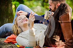 Couple in love tourists relaxing on picnic blanket. Vacation weekend picnic camping and hiking. Tourism concept. Picnic