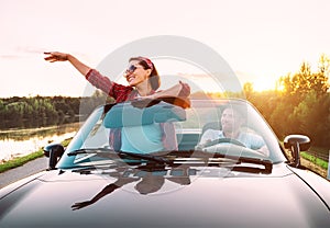 Couple in love traveling by cabriolet