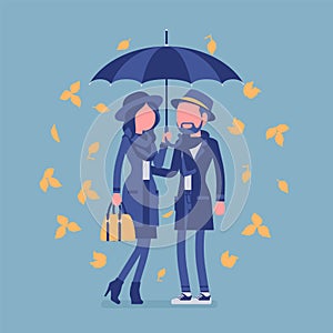 Couple in love with umbrella in autumn