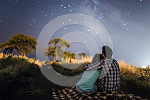 Couple in love under stars of Milky Way Galaxy