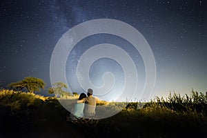 Couple in love under stars of Milky Way Galaxy