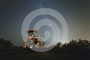 Couple in love under stars of Milky Way Galaxy