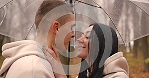 Couple in love under umbrella in the rain