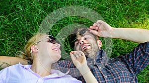 Couple in love united with nature. Nature fills them with freshness and inspiration. Man unshaven and girl lay on grass