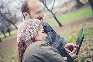 Couple in love using tablet connecting web wireless wifi