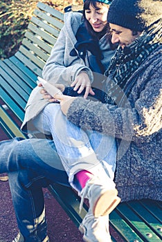 Couple in love using tablet at the park