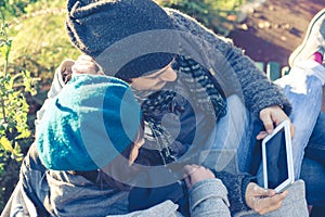 Couple in love using tablet at the park