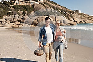 Couple, love and walking at beach for vacation, summer and smile for anniversary in nature. Man, woman and happiness