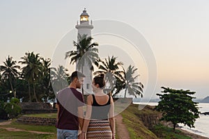 Couple in love walking in front of the lighthouse of Galle