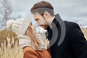 Couple in love walking in the Park, Valentine`s day. A man and a woman embrace and kiss, a couple in love, tender feelings