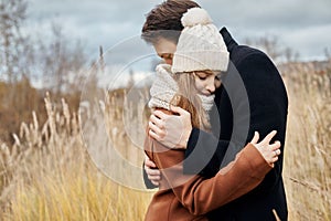 Couple in love walking in the Park, Valentine`s day. A man and a woman embrace and kiss, a couple in love, tender feelings