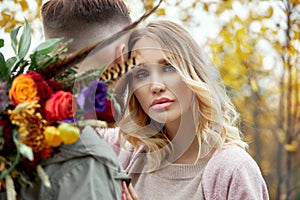 Couple in love walks through autumn forest. Hugs and kisses of men and women, relationships and love. Young couple stands in