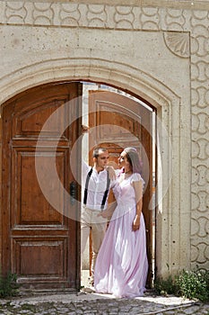 Couple in love walks and hugs on beautiful streets ancient city on summer day. Wedding couple waiting wedding ceremony