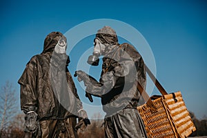 Couple in love walks in NBC protective suits and gas masks