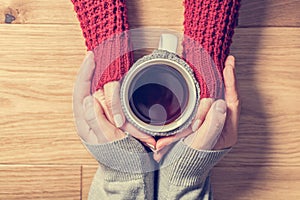 A couple in love warming hands with a hot mug of tea