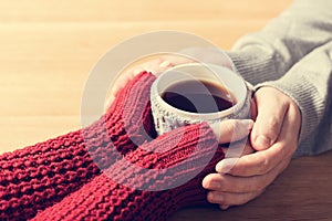 A couple in love warming hands with a hot mug of tea