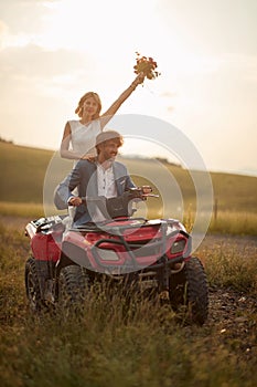 couple in love wedding in nature. romantic adventure man and woman at quad atv vehicle