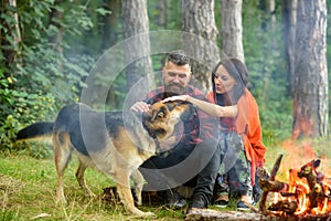 Couple in love, young happy family spend leisure with dog.