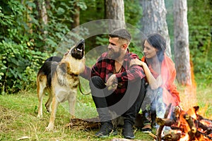 Couple in love, young happy family spend leisure with dog.