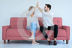 Couple lover hands clapping feeling happy and sitting on sofa at home,Cheerful and attractive people