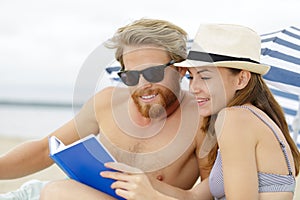 couple lover happy reading book on beach