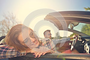 Couple of lovers driving on a convertible car - Newlywed pair on a romantic date