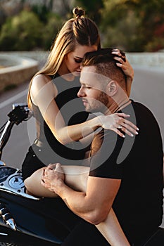 Couple of lovers kissing and hugging on motorbike