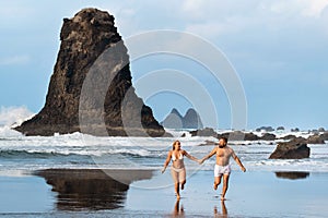 A couple of lovers on the sandy beach of Benijo on the island of Tenerife.Spain