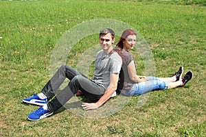 Couple of lovers sitting on meadow