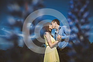 Couple in lupine flowers field