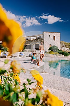 Couple on luxury vacation relaxing by the pool at an Agriturismo in Sicily Italy