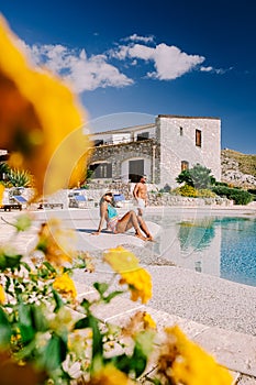 Couple on luxury vacation relaxing by the pool at an Agriturismo in Sicily Italy photo