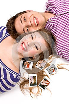 Couple lying down with polaroid pictures