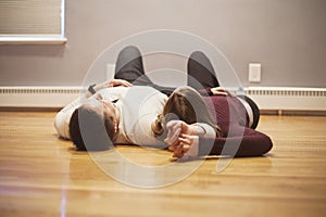 Couple lying on empty floor