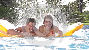 Couple lying on inflatable airbed