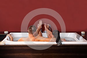 Couple lying in jacuzzi