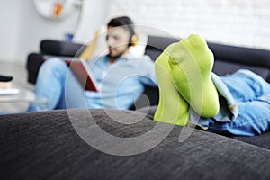 Couple Lying On Sofa With Tablet PC and Earphones