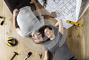 Couple lying on wooden floor