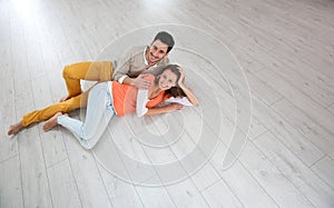 Couple lying on wooden floor