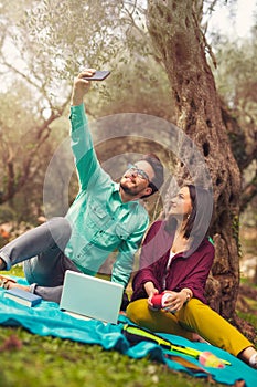 Couple make selfi under the olive tree